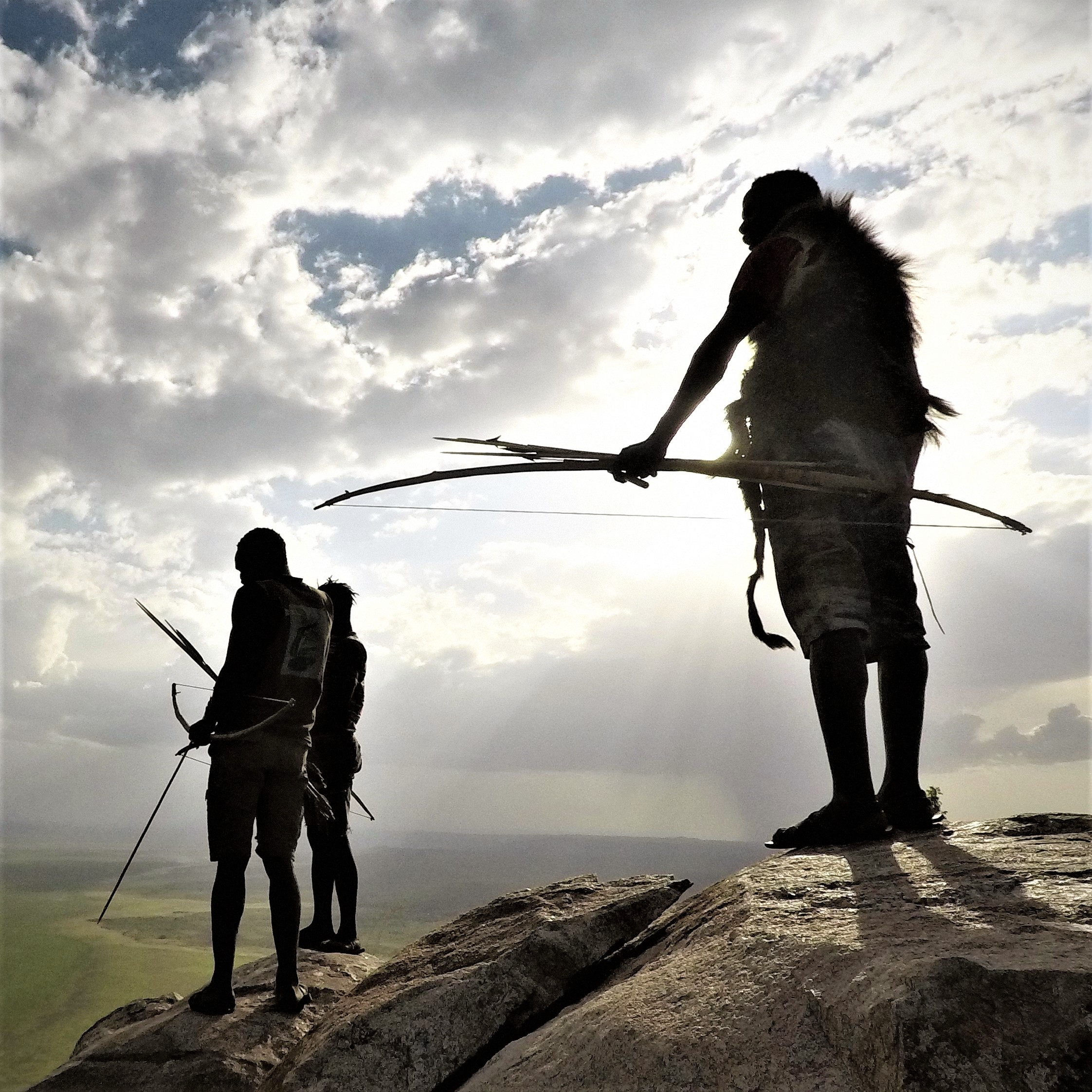 Hadza men resting on a rock above the Yaeda Valley
