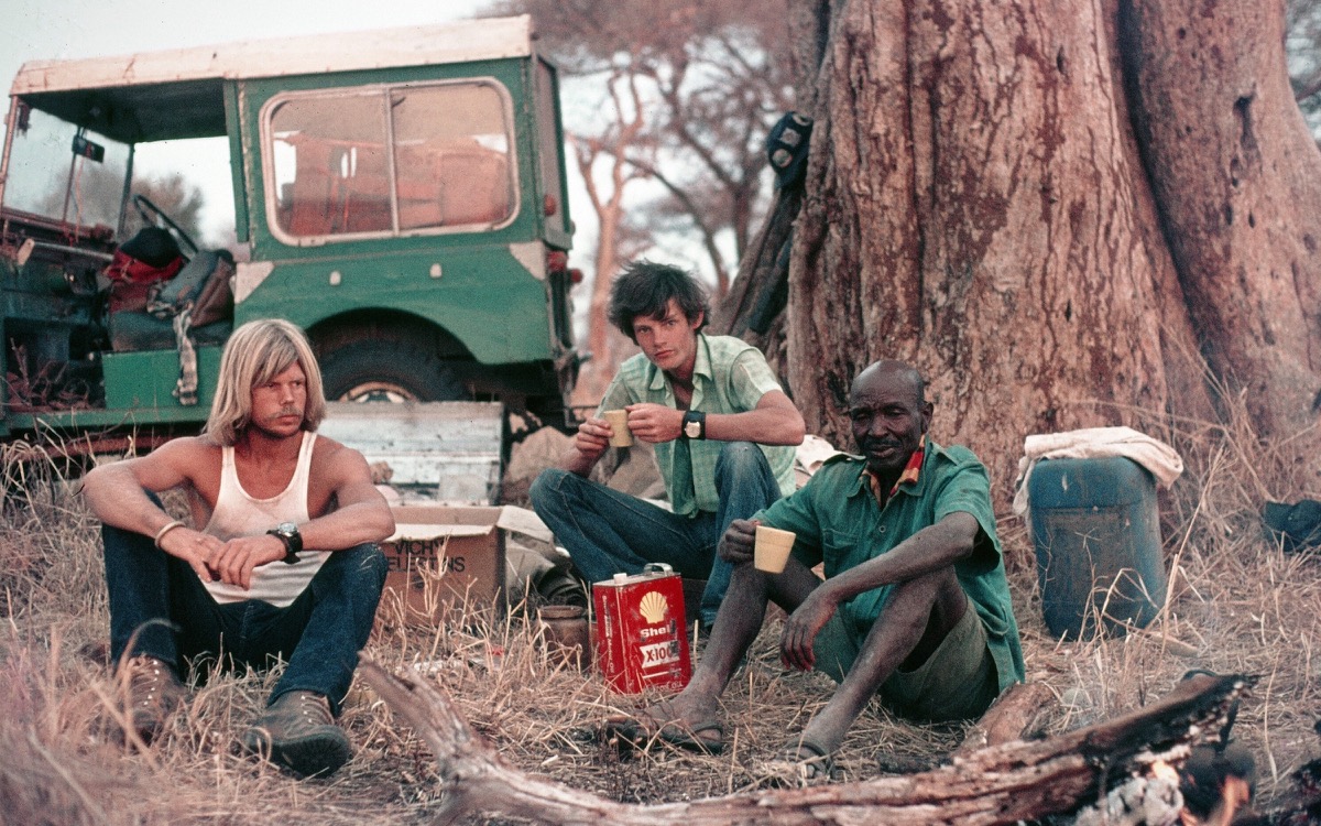 The Dorobo founders at a fireside camp beside a Land Rover in the 1980s