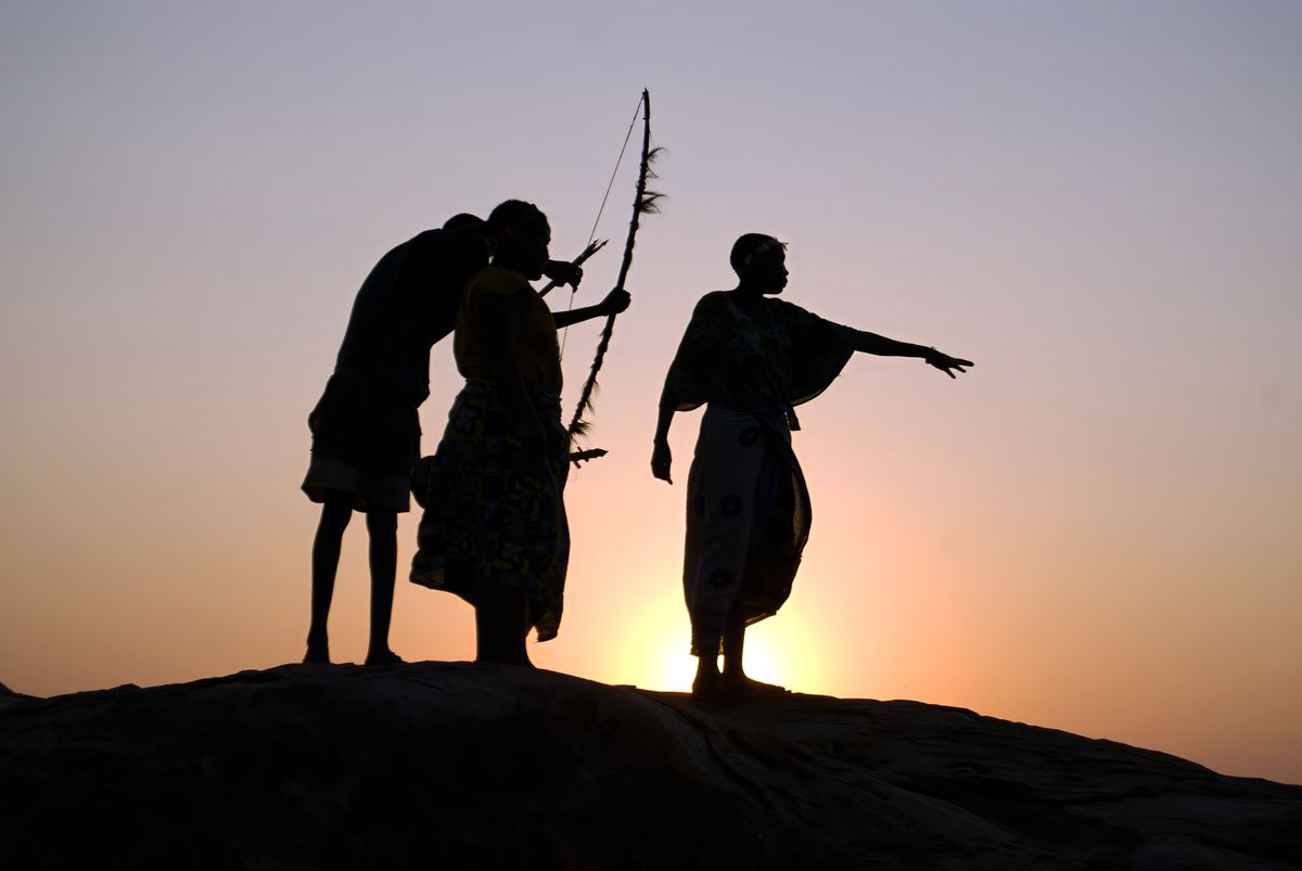 Dorobo Hadza guides silhouetted against the sunset